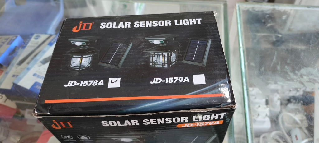 The JD-1578A Solar Sensor Light is an outdoor wall lamp featuring a built-in motion sensor, dual solar charging capability, and adjustable warm/white LED lighting modes.