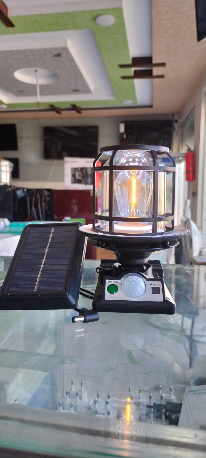 The JD-1578A Solar Sensor Light is an outdoor wall lamp featuring a built-in motion sensor, dual solar charging capability, and adjustable warm/white LED lighting modes.