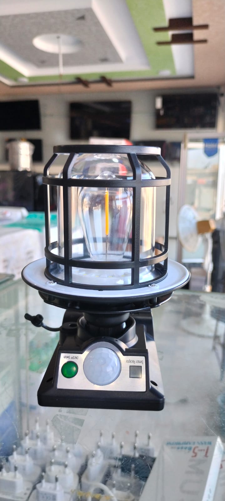 The JD-1578A Solar Sensor Light is an outdoor wall lamp featuring a built-in motion sensor, dual solar charging capability, and adjustable warm/white LED lighting modes.